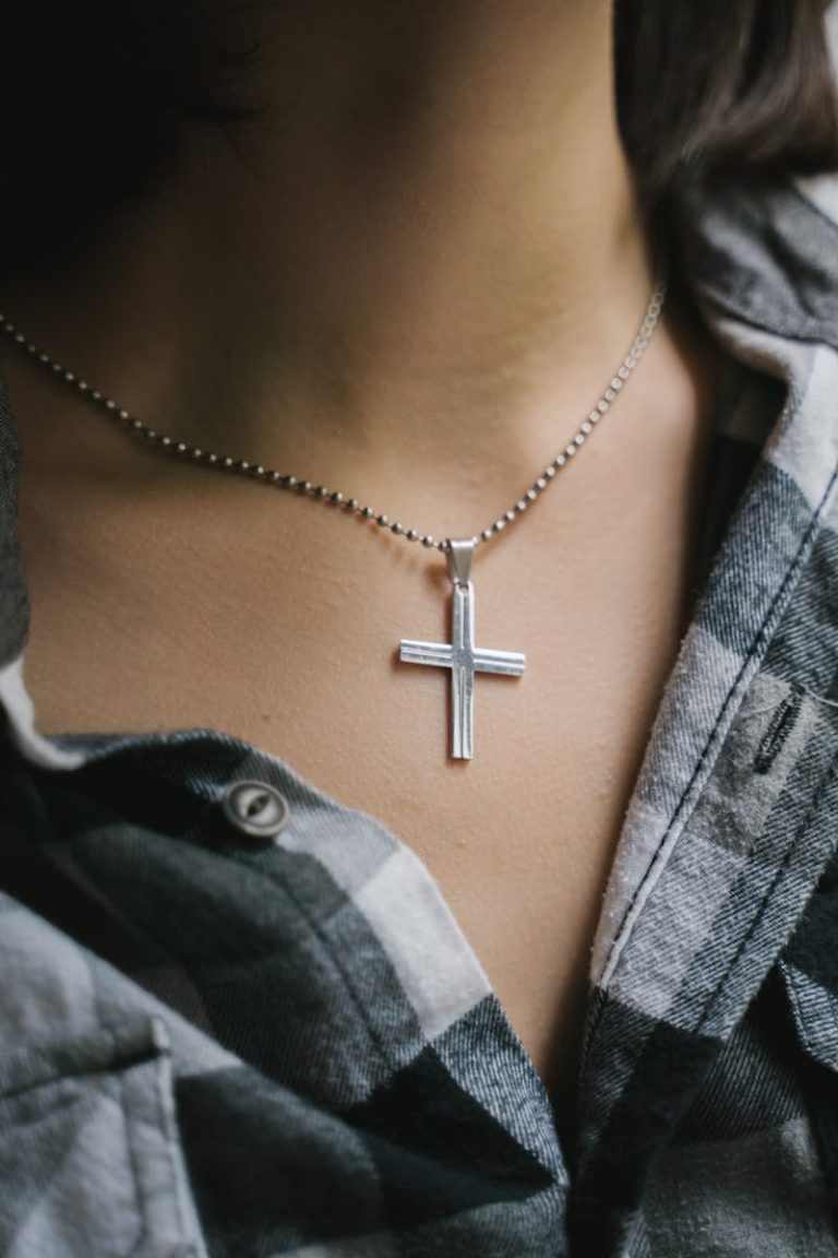 A Person Wearing a Cross Necklace