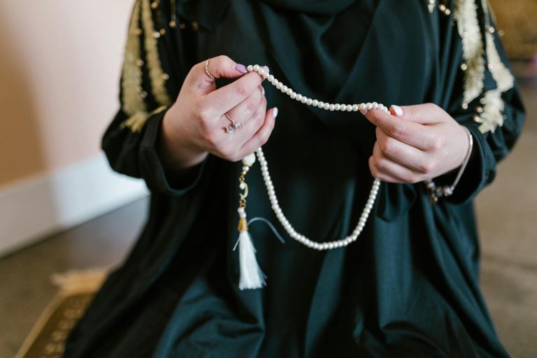 Person Holding White Beaded Necklace