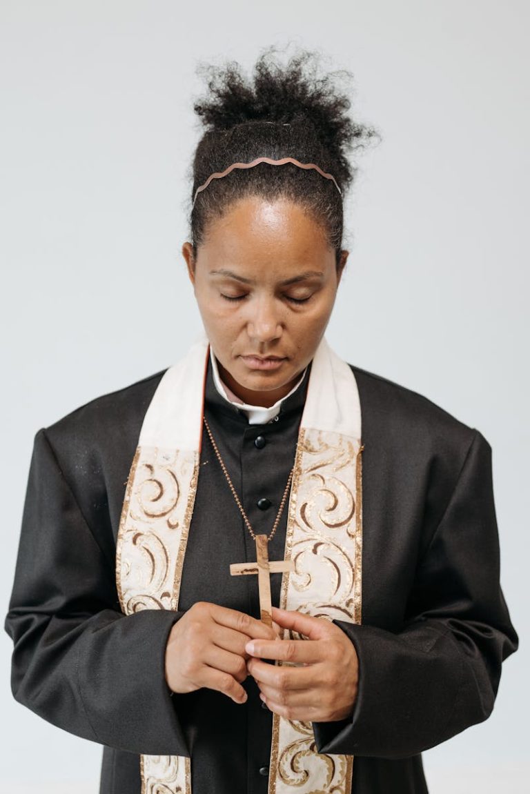 Female Priest Praying with Eyes Closed