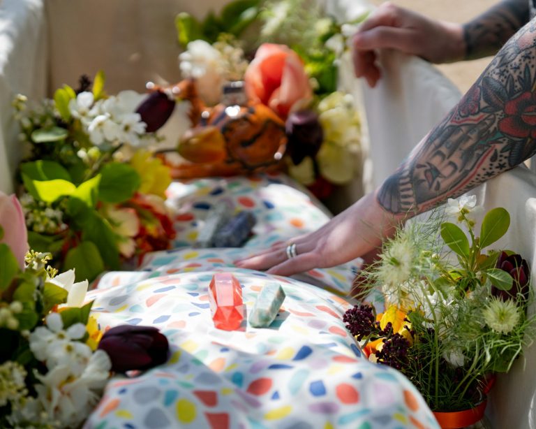 a person reaching for a flower on a table